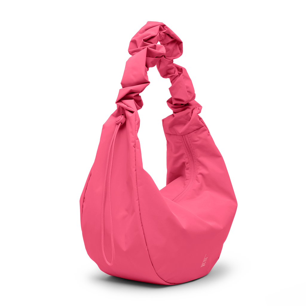 MOON BAG RUFFLE Tasche in salina pink (leuchtendes Pink) als Studioaufnahme in diagonaler Ansicht.
